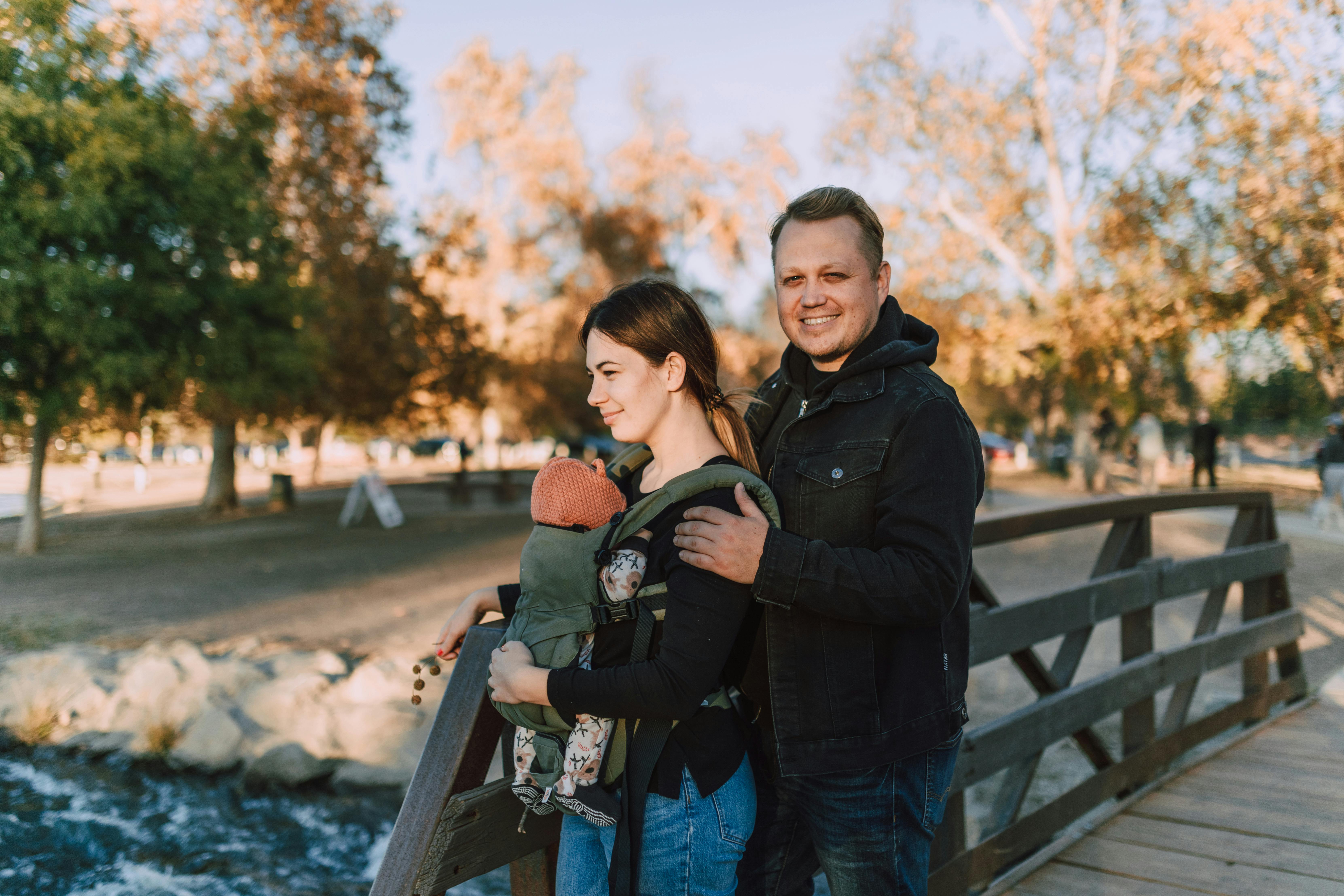Couple with baby on a bridge